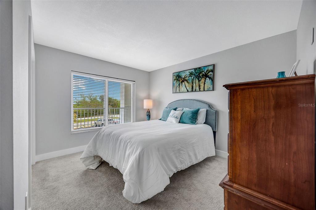 4620 Bay Boulevard, Unit 1117 Port Richey, FL 34668 - Photo 19 of 37 a bedroom with a bed and a window