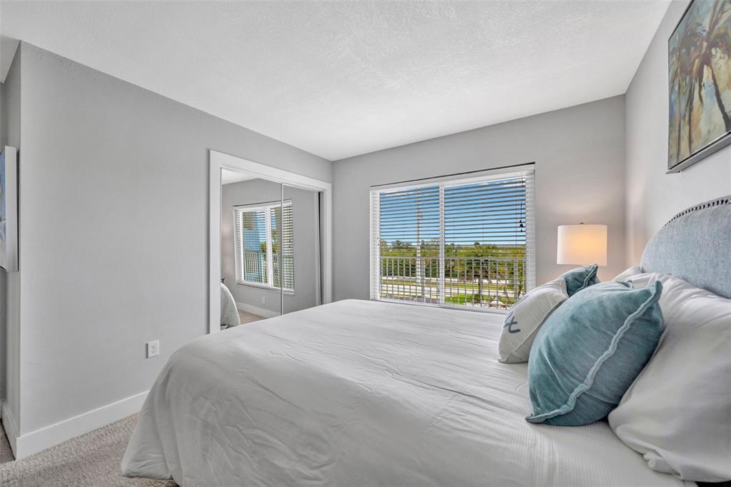 4620 Bay Boulevard, Unit 1117 Port Richey, FL 34668 - Photo 20 of 37 a large bed sitting in a bedroom next to a window
