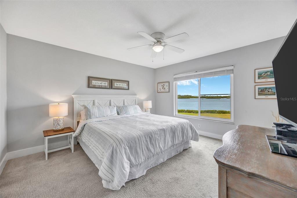 4620 Bay Boulevard, Unit 1117 Port Richey, FL 34668 - Photo 22 of 37 a bedroom with a bed and a flat screen tv