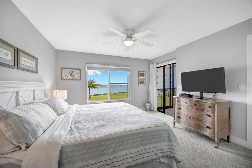 4620 Bay Boulevard, Unit 1117 Port Richey, FL 34668 - Photo 23 of 37 a bedroom with a bed and a flat screen tv