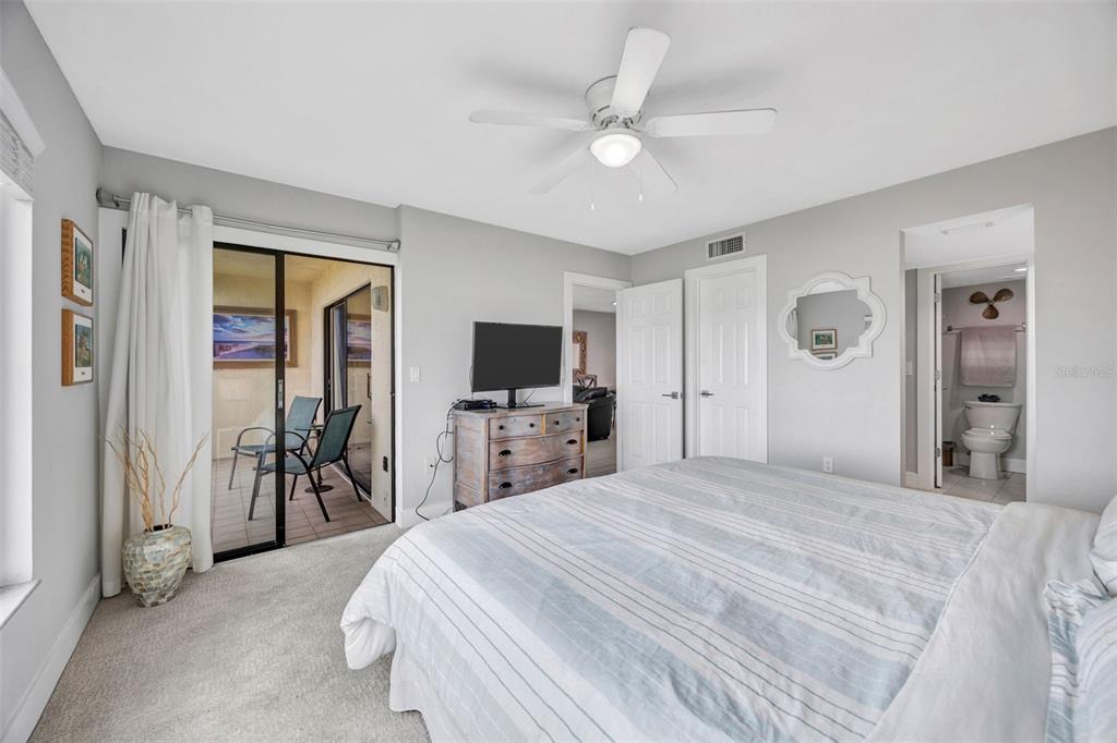 4620 Bay Boulevard, Unit 1117 Port Richey, FL 34668 - Photo 24 of 37 a bedroom with a bed and a flat screen tv