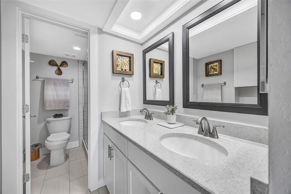 4620 Bay Boulevard, Unit 1117 Port Richey, FL 34668 - Photo 26 of 37 a bathroom with a granite countertop sink mirror and toilet