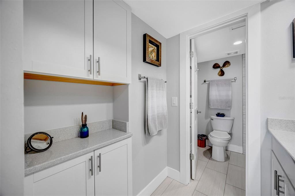 4620 Bay Boulevard, Unit 1117 Port Richey, FL 34668 - Photo 27 of 37 a bathroom with a sink a toilet and shower