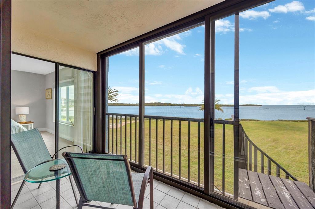 4620 Bay Boulevard, Unit 1117 Port Richey, FL 34668 - Photo 29 of 37 a view of a balcony with chair and floor to ceiling window