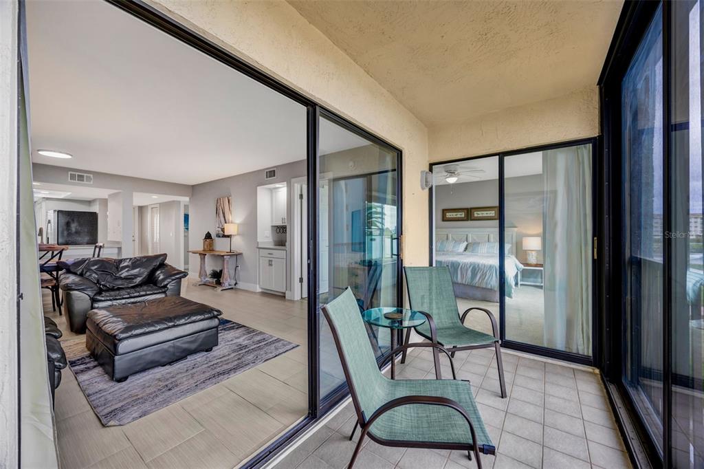 4620 Bay Boulevard, Unit 1117 Port Richey, FL 34668 - Photo 30 of 37 a living room with furniture and a floor to ceiling window