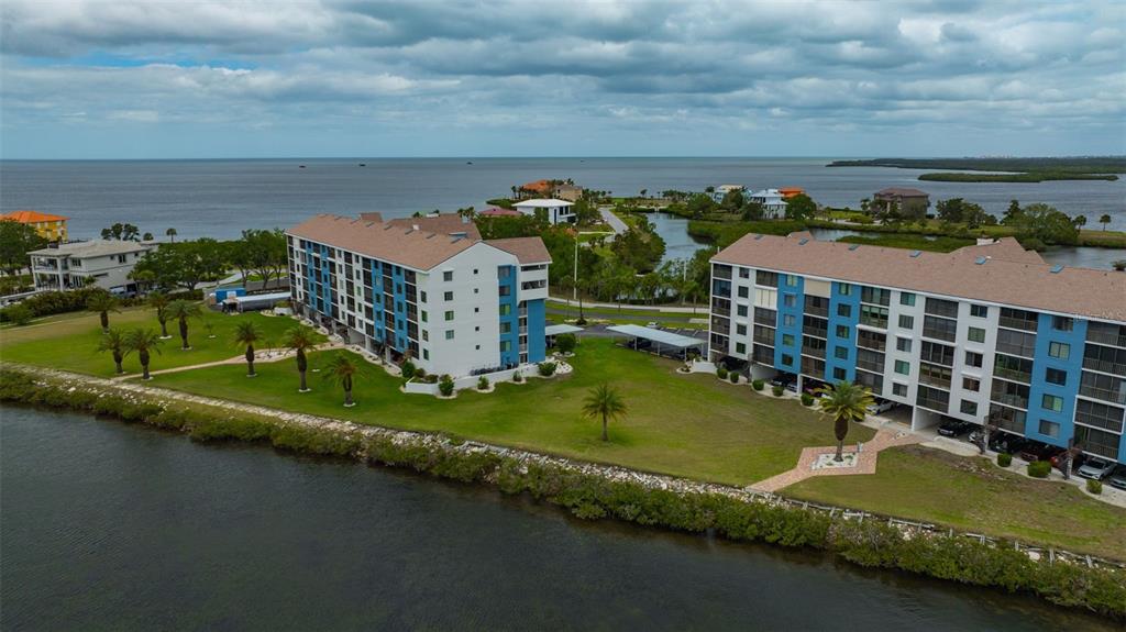 4620 Bay Boulevard, Unit 1117 Port Richey, FL 34668 - Photo 3 of 37 an aerial view of a house with a garden and lake view