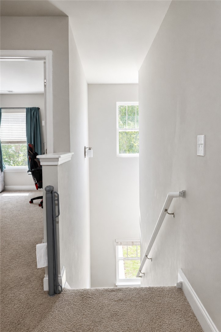 102 Ventura Street Anderson, SC 29621 - Photo 12 of 24 A well-lit stairwell, providing seamless transitions between floors with plush carpeting.