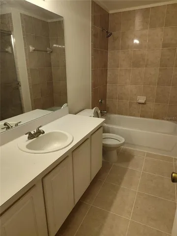 a bathroom with a toilet and a rug