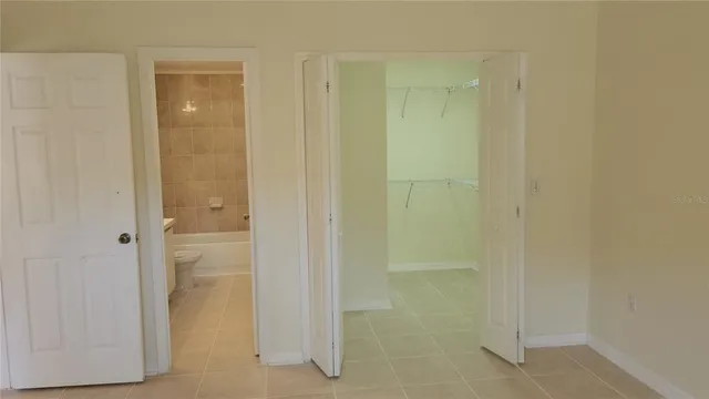 a view of a kitchen with a refrigerator and a sink