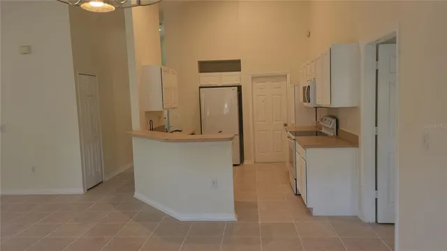 a utility room with cabinets washer and dryer