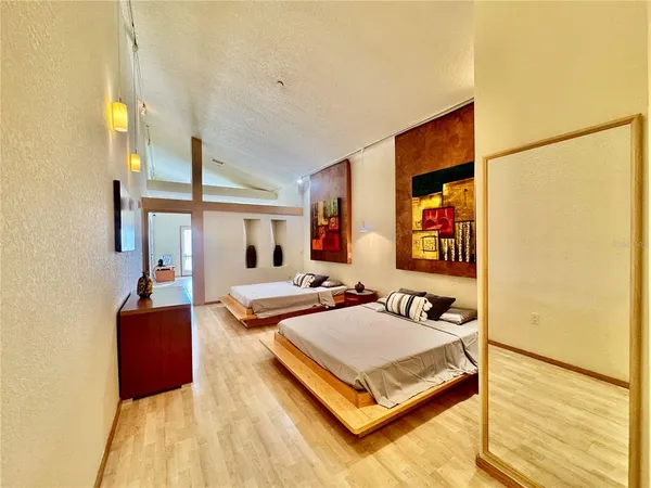 a bedroom with furniture and a flat screen tv