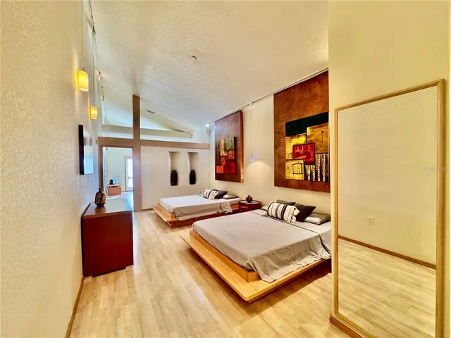 a bedroom with furniture and a flat screen tv