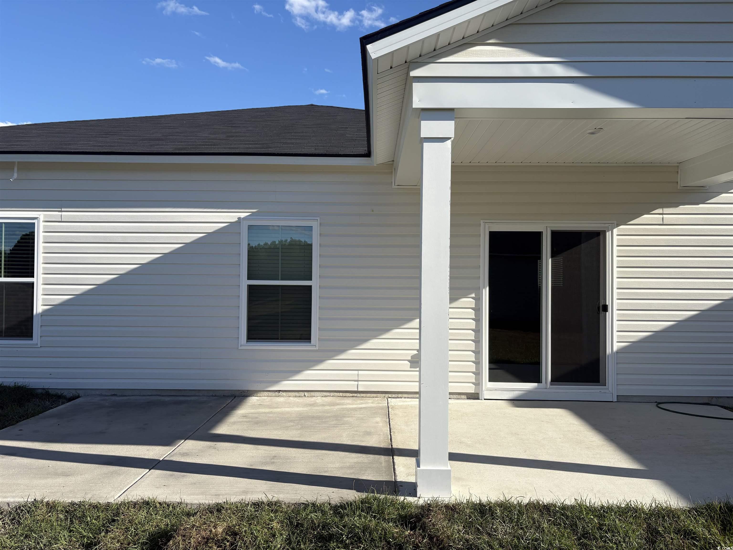 820 Wapama Street Little River, SC 29566 - Photo 14 of 15 Entrance to property with a patio area and a shingled roof