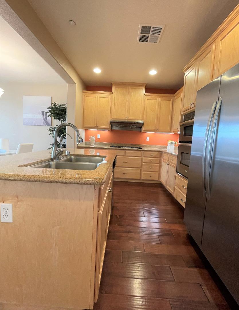 5150 Fioli Loop San Ramon, CA 94582 - Photo 12 of 38 a kitchen with kitchen island granite countertop stainless steel appliances lots of counter top space