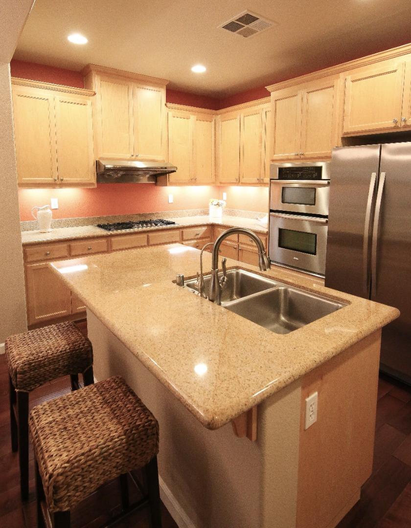 5150 Fioli Loop San Ramon, CA 94582 - Photo 13 of 38 a kitchen with a sink a stove a refrigerator and white cabinets