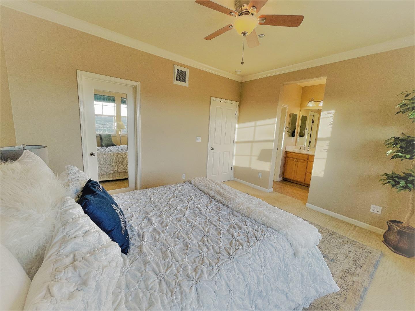 5150 Fioli Loop San Ramon, CA 94582 - Photo 20 of 38 a bedroom with a bed and a chandelier
