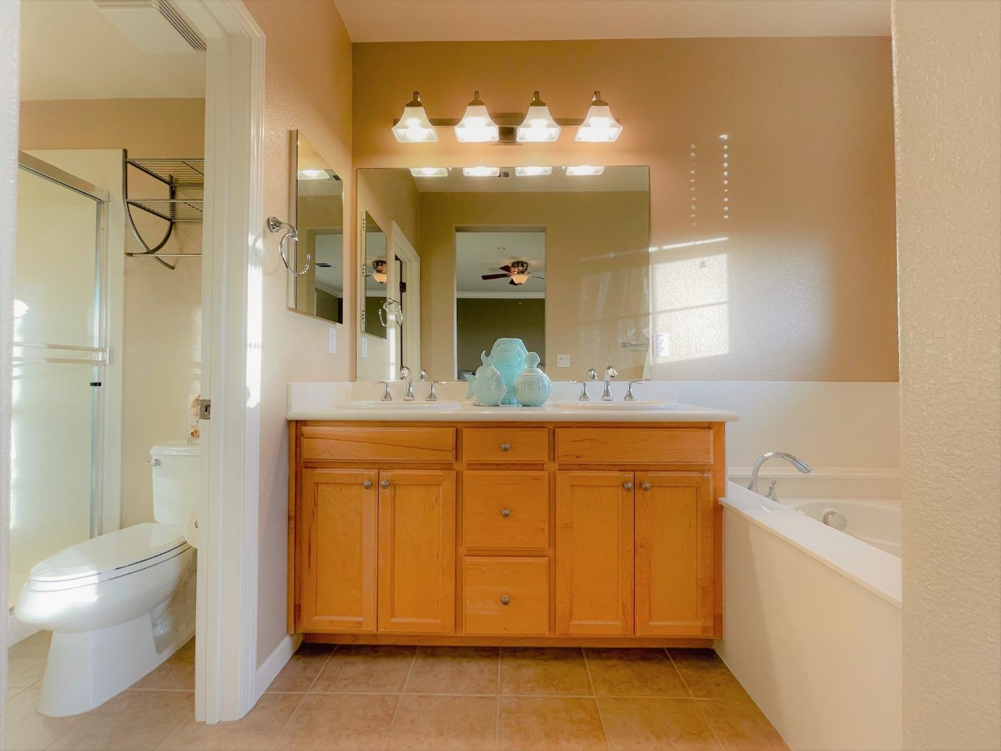 5150 Fioli Loop San Ramon, CA 94582 - Photo 22 of 38 a bathroom with a granite countertop sink mirror vanity and toilet