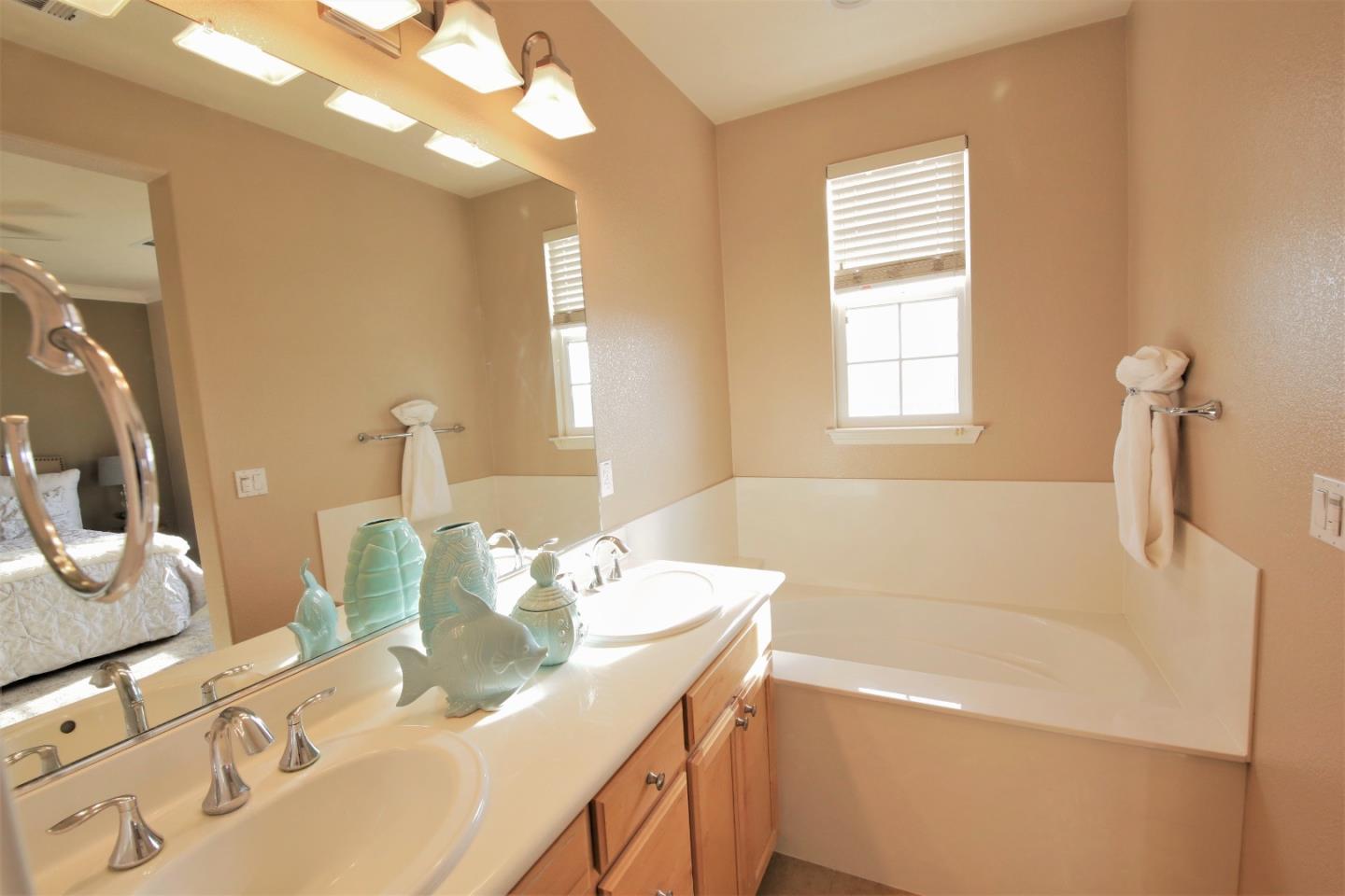 5150 Fioli Loop San Ramon, CA 94582 - Photo 23 of 38 a bathroom with a tub sink and a mirror