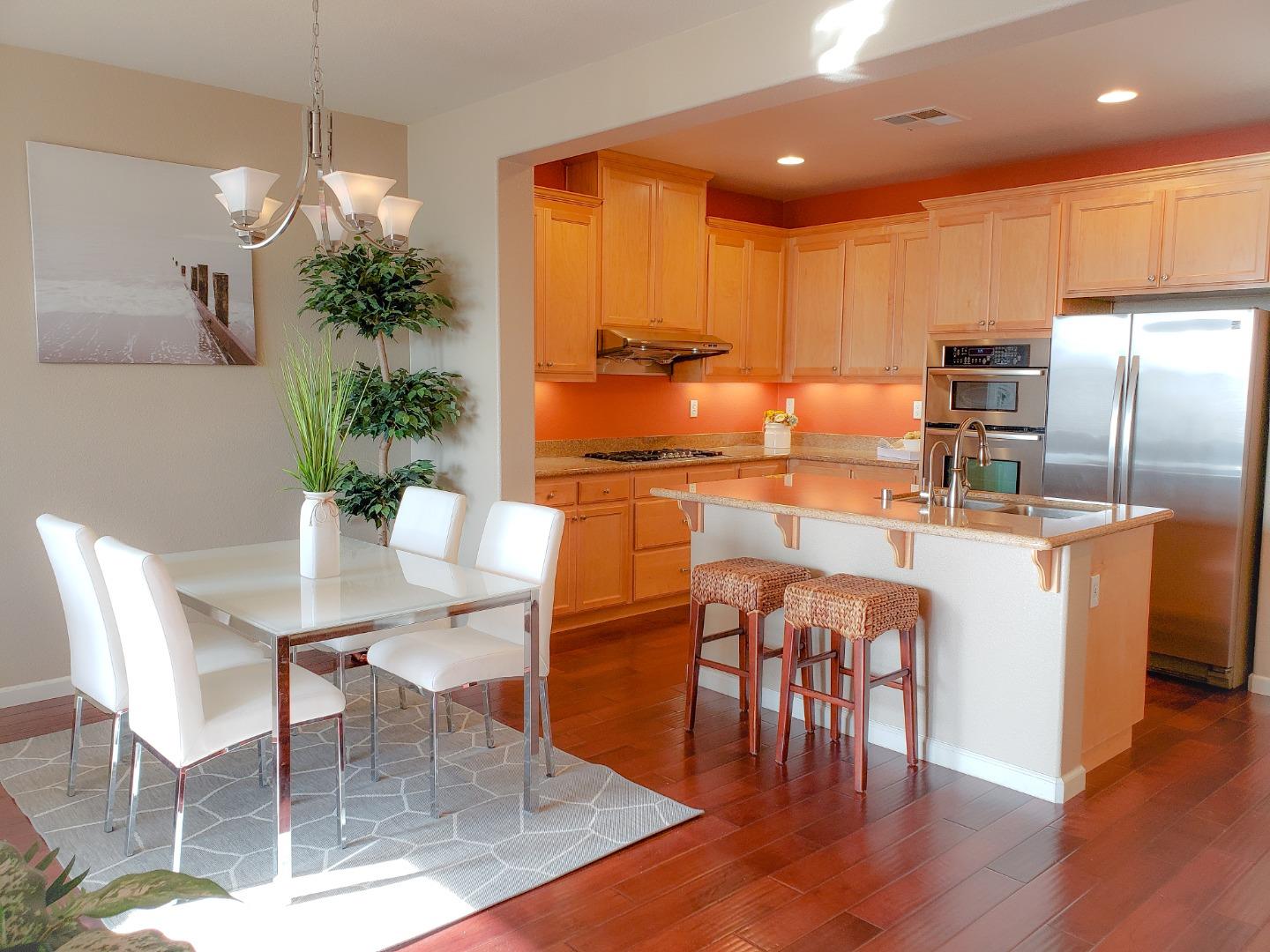 5150 Fioli Loop San Ramon, CA 94582 - Photo 6 of 38 a kitchen with granite countertop kitchen island stainless steel appliances a dining table chairs and granite counter tops