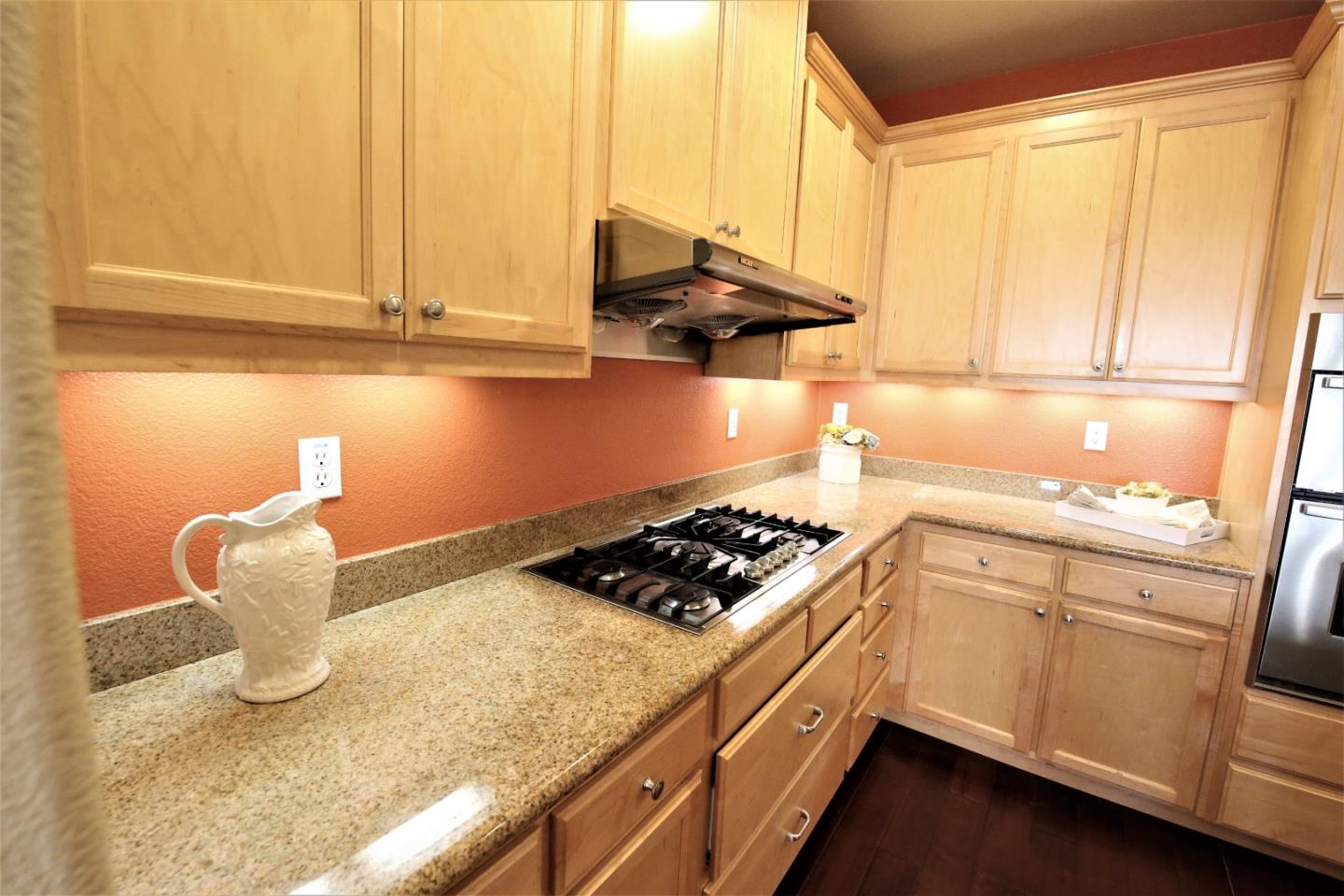 5150 Fioli Loop San Ramon, CA 94582 - Photo 10 of 38 a kitchen with stainless steel appliances granite countertop a sink and a stove