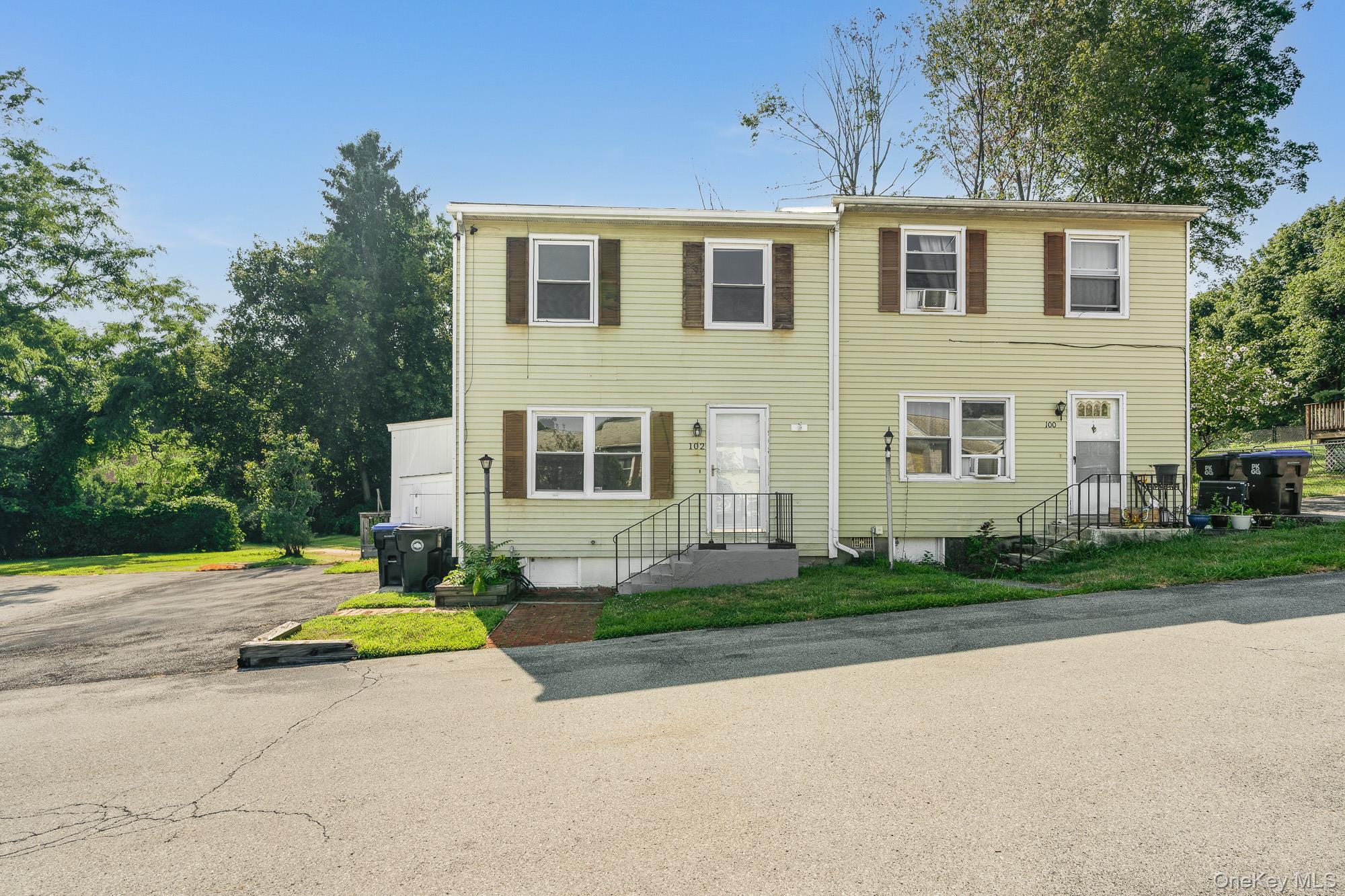102 Rinaldi Boulevard Poughkeepsie, NY 12601 - Photo 1 of 1 a front view of a house with a yard and trees