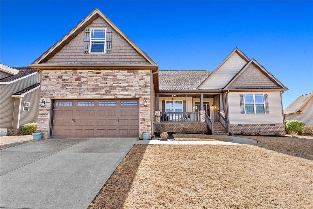 409 Coldstream Court Seneca, SC 29678 - Photo 1 of 40 This residence features a charming front porch, a practical attached garage, and tasteful stone accents.