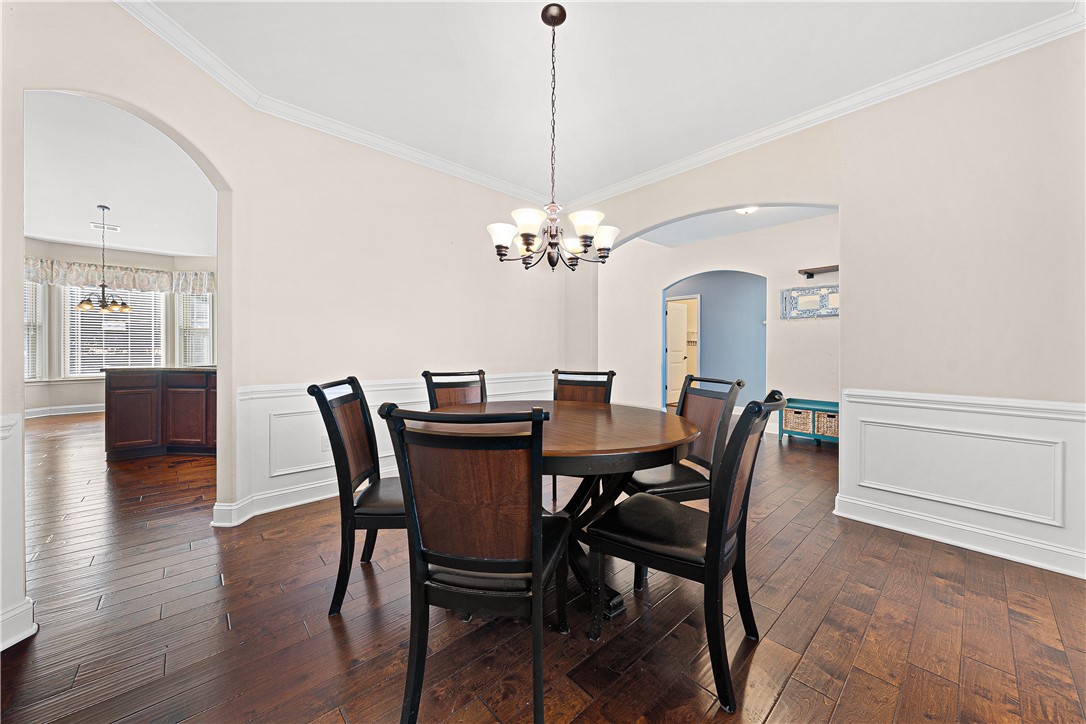 409 Coldstream Court Seneca, SC 29678 - Photo 11 of 40 Elegant dining room with classic archways and rich hardwood floors offers seamless flow.