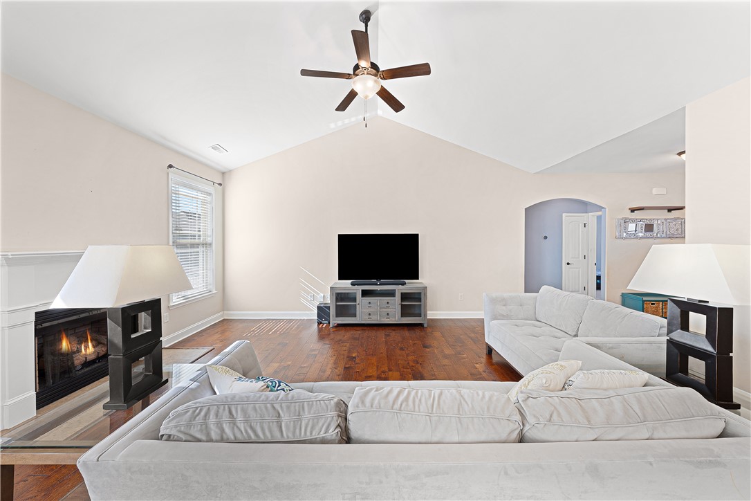 409 Coldstream Court Seneca, SC 29678 - Photo 13 of 40 This inviting living area boasts rich hardwood floors and a cozy fireplace, perfect for gatherings.
