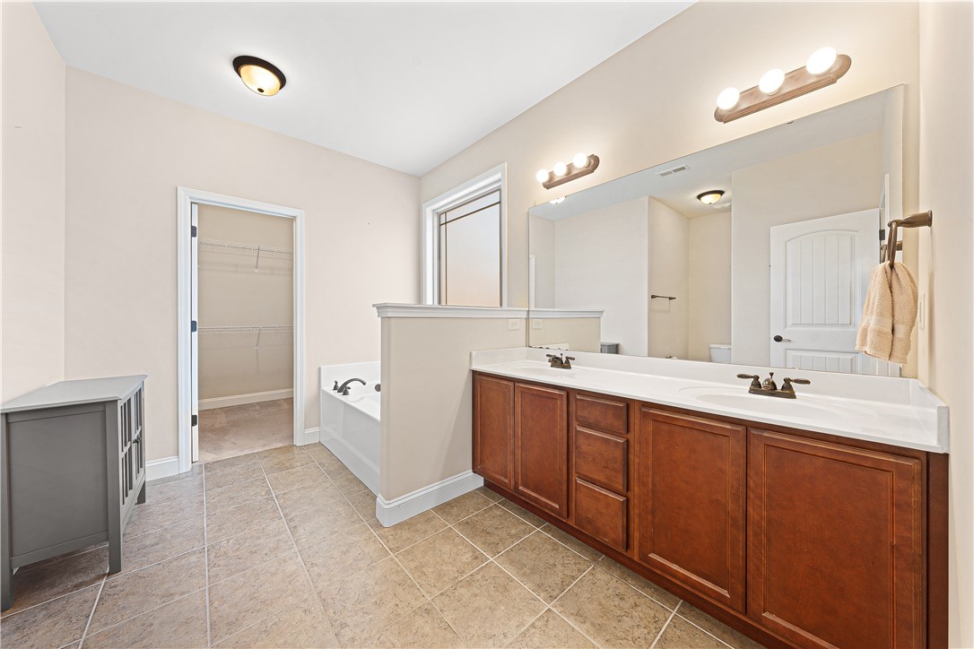 409 Coldstream Court Seneca, SC 29678 - Photo 21 of 40 This spacious primary bathroom features a dual vanity, a soaking tub, and ample natural light.