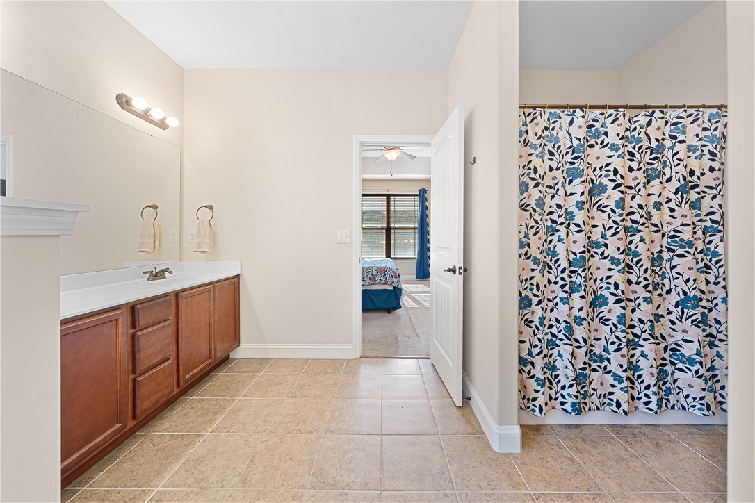 409 Coldstream Court Seneca, SC 29678 - Photo 22 of 40 This bathroom features a single vanity with ample storage and a shower with a privacy curtain.