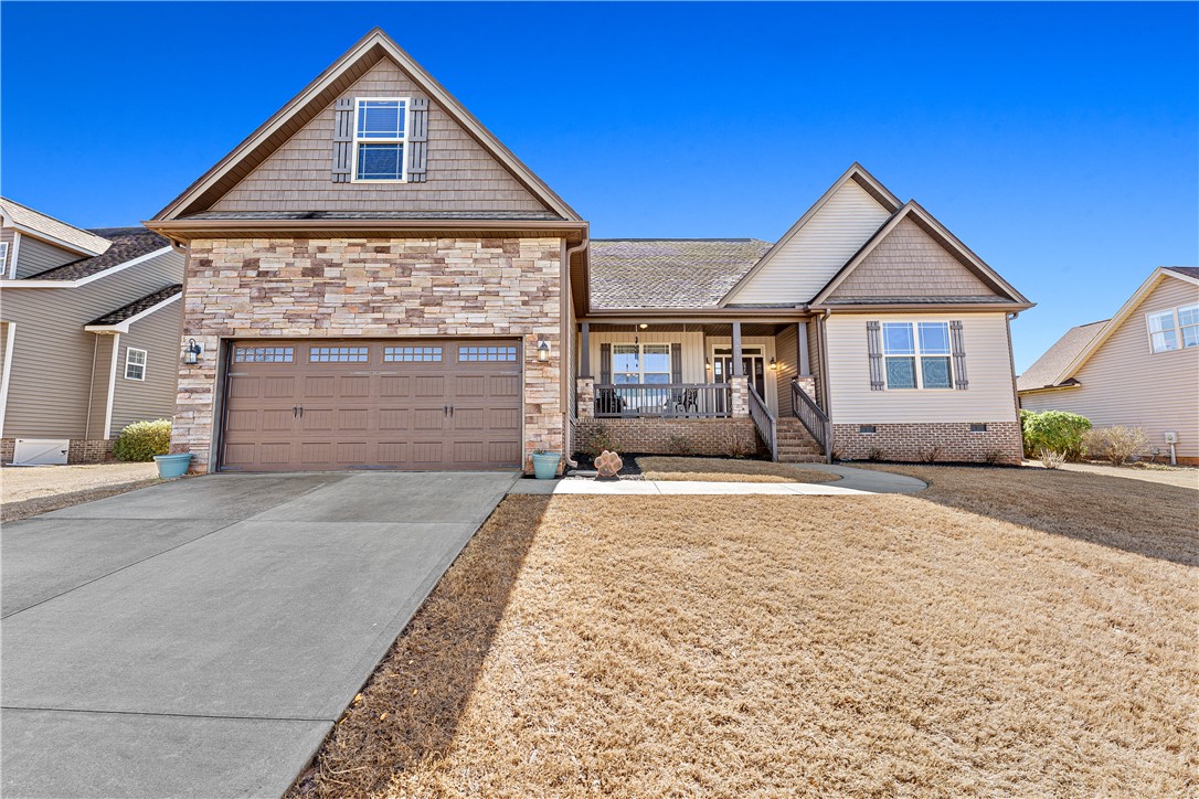 409 Coldstream Court Seneca, SC 29678 - Photo 3 of 40 This charming home offers an inviting facade, a convenient garage, and a welcoming front porch.