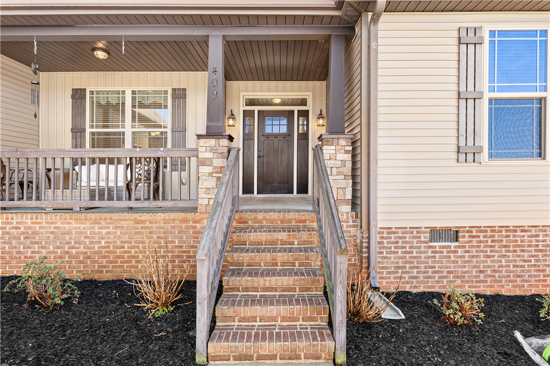 409 Coldstream Court Seneca, SC 29678 - Photo 4 of 40 This charming residence features a welcoming entrance with a covered porch and brick accents.