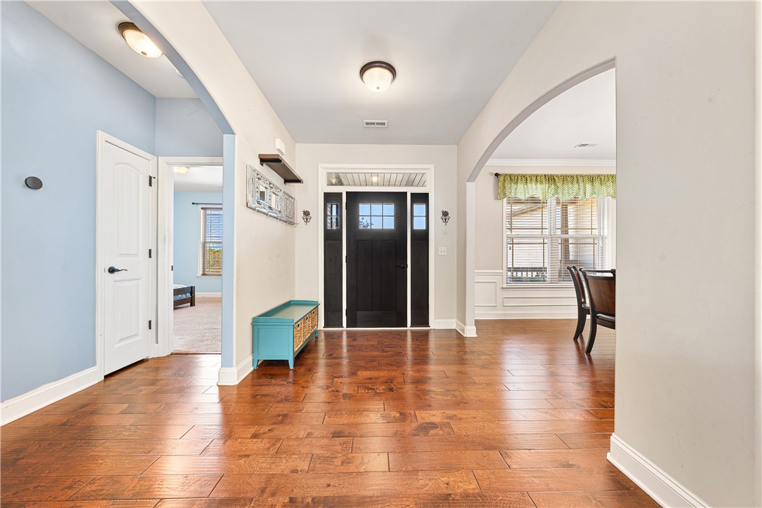 409 Coldstream Court Seneca, SC 29678 - Photo 8 of 40 The bright entrance foyer features hardwood flooring and architectural archways.