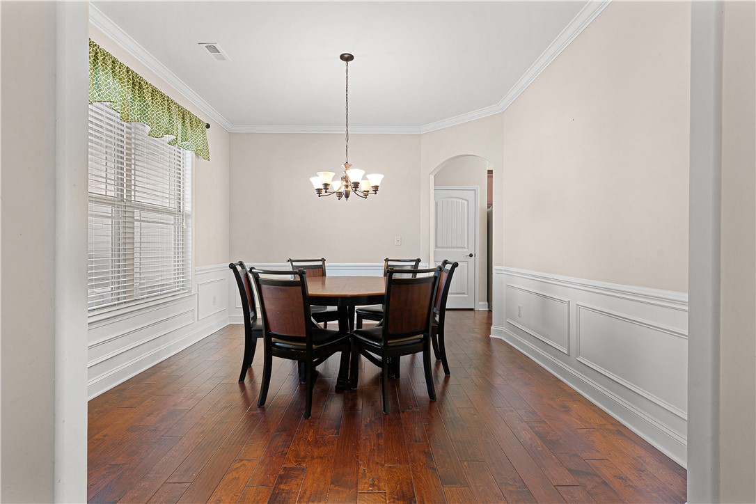 409 Coldstream Court Seneca, SC 29678 - Photo 9 of 40 This formal dining room features elegant wainscoting and hardwood floors, creating an inviting space.