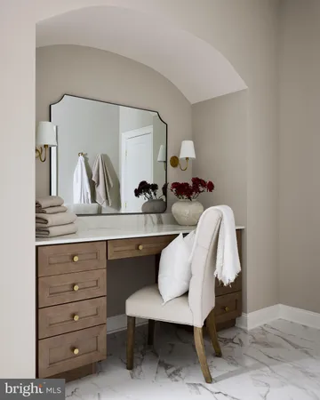 a close view of a sink a mirror and cabinets