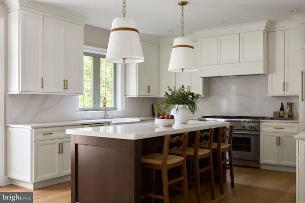 a kitchen with a sink stove and white cabinets