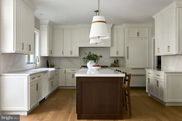 a kitchen with stainless steel appliances granite countertop a sink a stove and a wooden floors