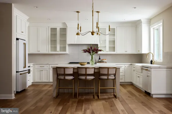 a kitchen with white cabinets and appliances