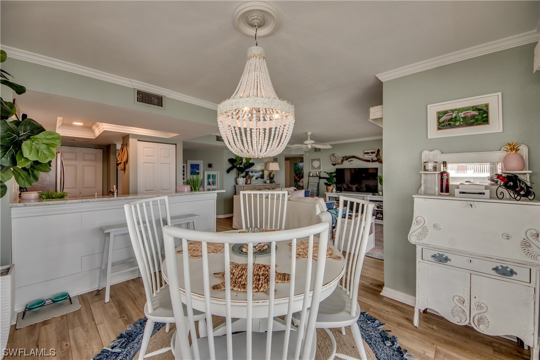 16611 Stringfellow Road, Unit 203 Bokeelia, FL 33922 - Photo 11 of 48 a view of a dining room with furniture window and wooden floor