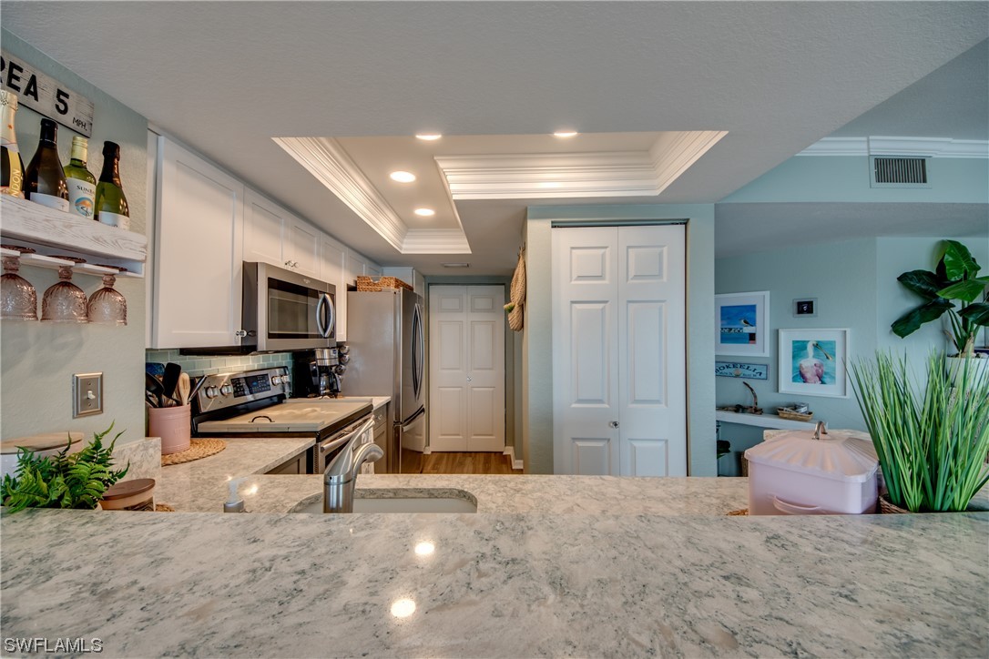 16611 Stringfellow Road, Unit 203 Bokeelia, FL 33922 - Photo 12 of 48 a view of a livingroom with workspace and a couch