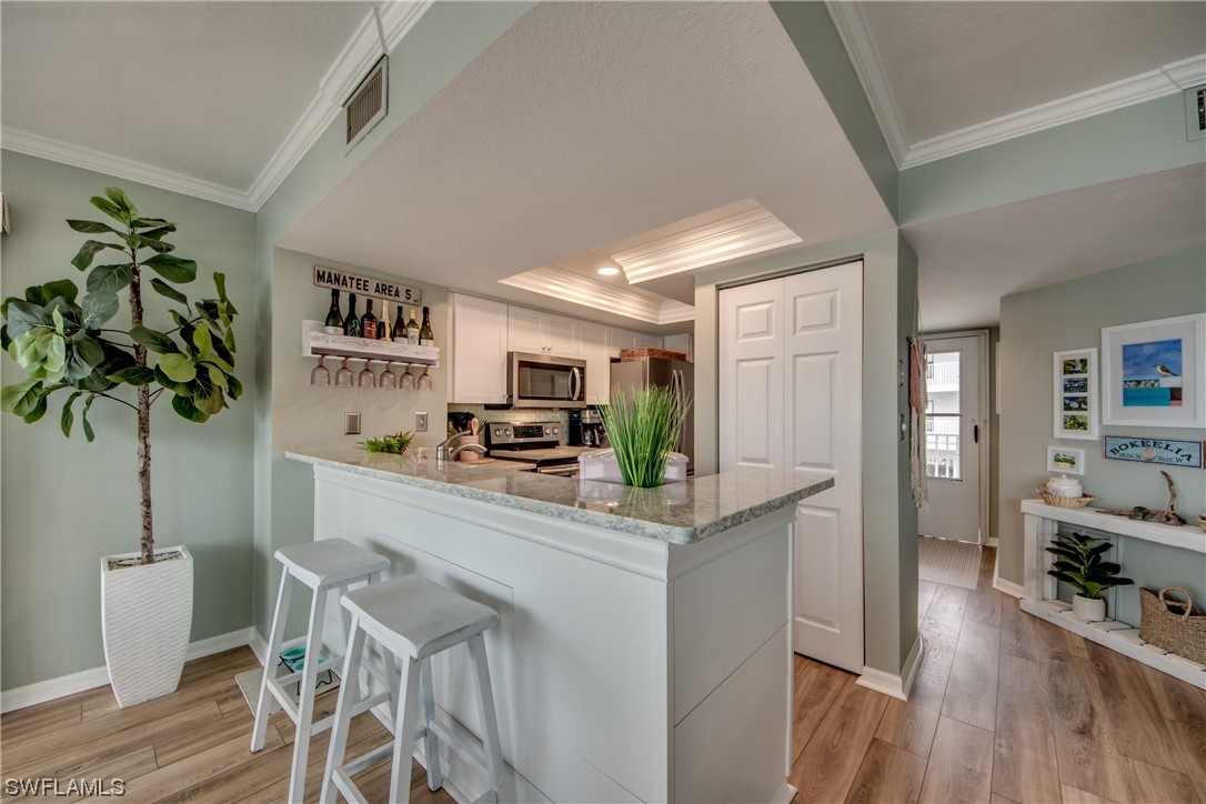 16611 Stringfellow Road, Unit 203 Bokeelia, FL 33922 - Photo 13 of 48 a kitchen with stainless steel appliances a counter top space and cabinets