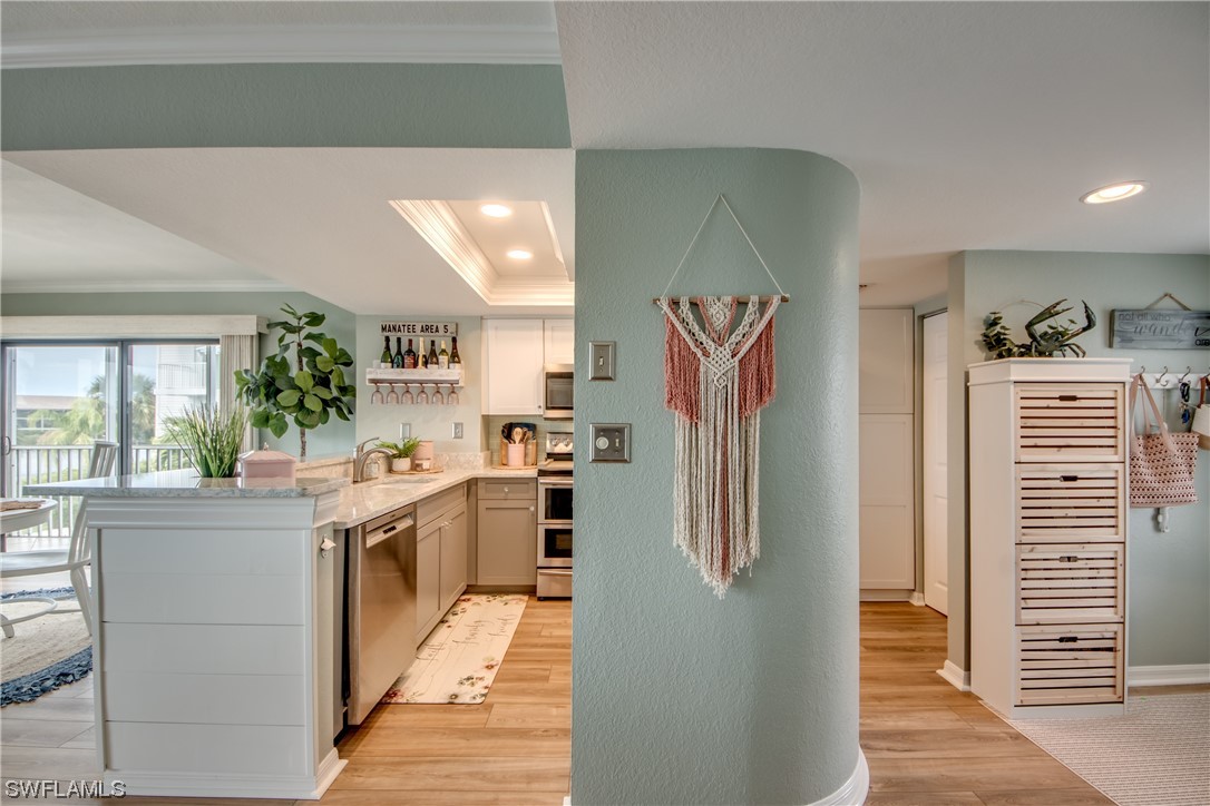 16611 Stringfellow Road, Unit 203 Bokeelia, FL 33922 - Photo 14 of 48 a kitchen with stainless steel appliances granite countertop a refrigerator and a stove top oven