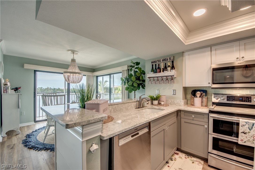 16611 Stringfellow Road, Unit 203 Bokeelia, FL 33922 - Photo 16 of 48 a kitchen with a sink stove and microwave