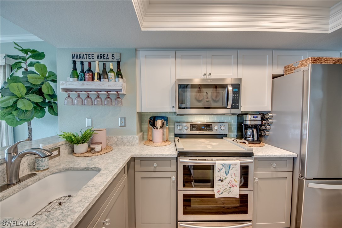16611 Stringfellow Road, Unit 203 Bokeelia, FL 33922 - Photo 17 of 48 a kitchen with granite countertop a refrigerator and a sink