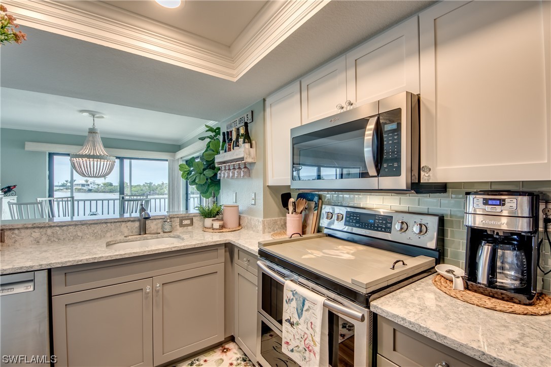 16611 Stringfellow Road, Unit 203 Bokeelia, FL 33922 - Photo 18 of 48 a kitchen with a stove and a sink