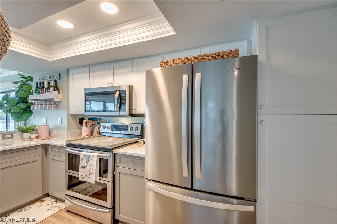 16611 Stringfellow Road, Unit 203 Bokeelia, FL 33922 - Photo 19 of 48 a kitchen with stainless steel appliances a refrigerator and a sink