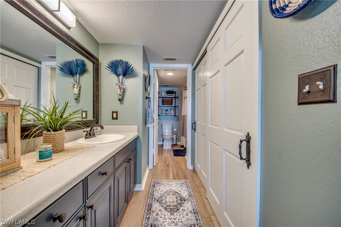 16611 Stringfellow Road, Unit 203 Bokeelia, FL 33922 - Photo 23 of 48 a bathroom with a sink a potted plant and a mirror