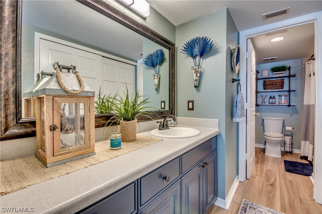 16611 Stringfellow Road, Unit 203 Bokeelia, FL 33922 - Photo 24 of 48 a bathroom with a sink a toilet and shower