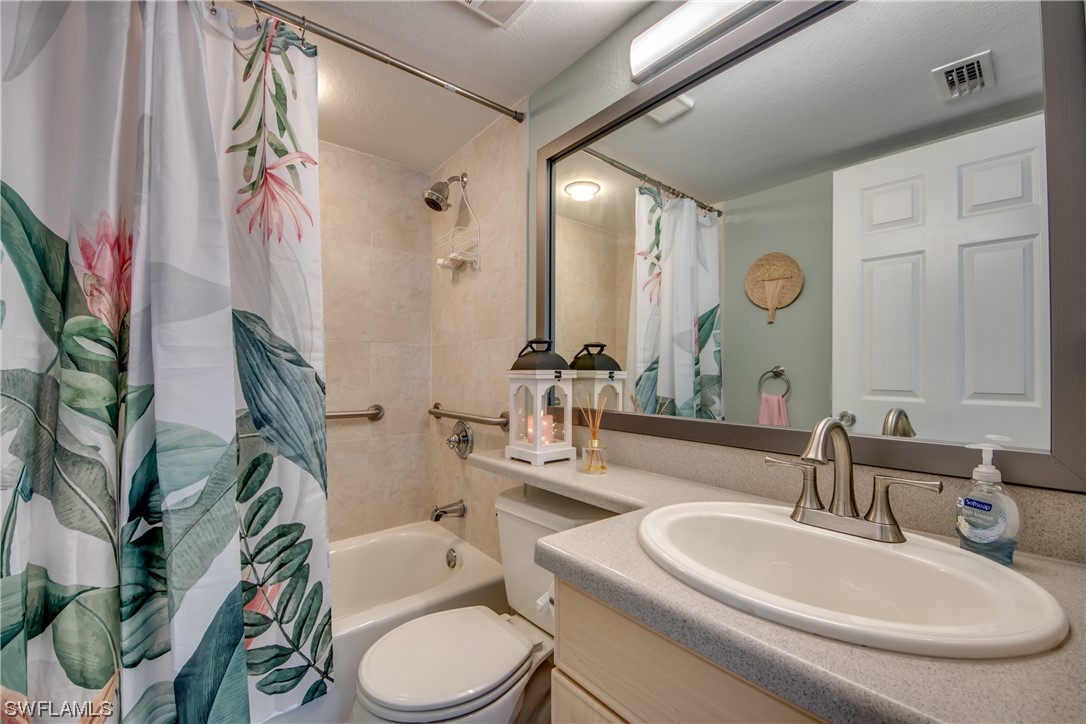 16611 Stringfellow Road, Unit 203 Bokeelia, FL 33922 - Photo 28 of 48 a bathroom with a toilet a sink and a mirror