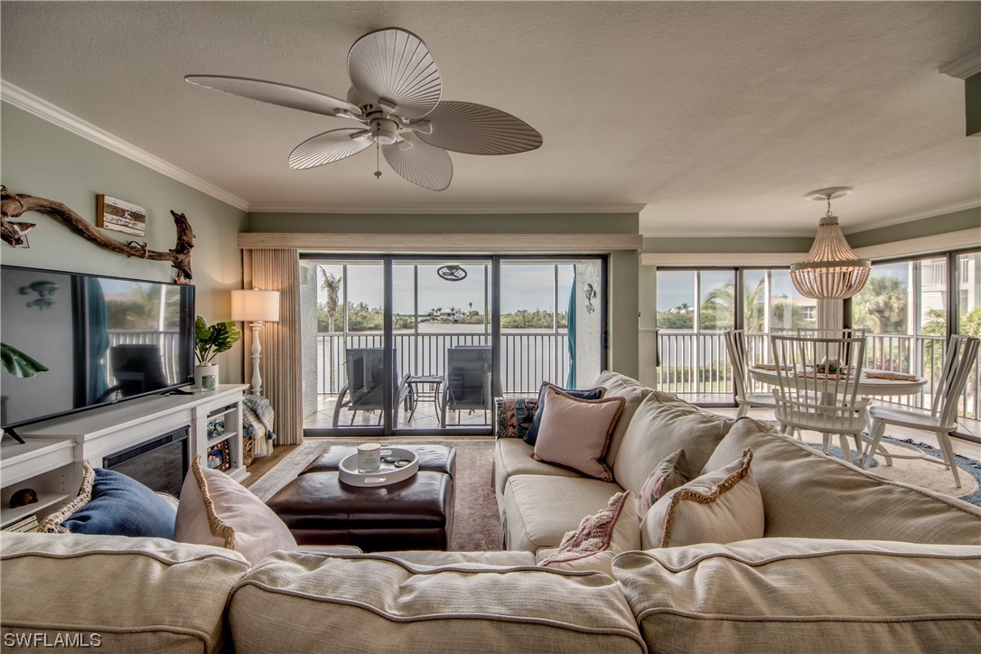 16611 Stringfellow Road, Unit 203 Bokeelia, FL 33922 - Photo 3 of 48 a living room with furniture and a flat screen tv